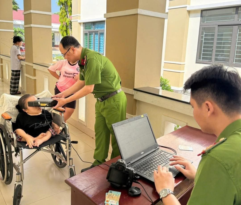 Cán bộ Phòng Cảnh sát Quản lý hành chính về trật tự xã hội, Công an tỉnh Quảng Ngãi hỗ trợ cấp cấp căn cước, định danh điện tử lưu động cho người khuyết tật trên địa bàn.